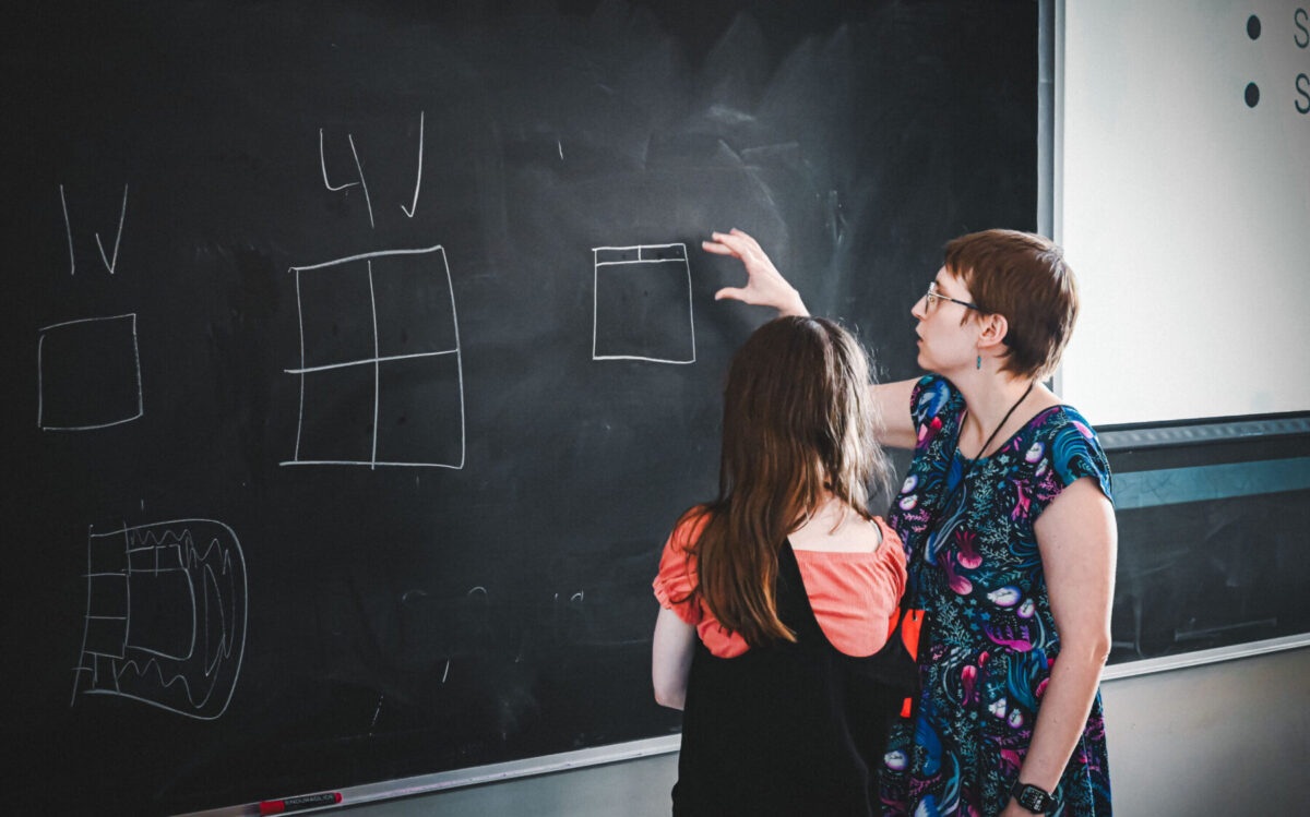 Faculty & Camper at the board at Conway